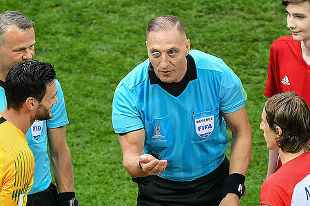 Referee Nestor Pitana flips a coin before the World Cup final soccer match between France and Croatia at the Luzhniki stadium, in Moscow, Russia, July 15, 2018.